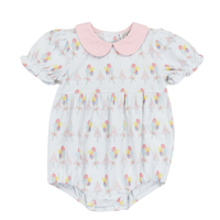 White Bubble romper with a pink collar that is printed with balloons and a birthday cake
