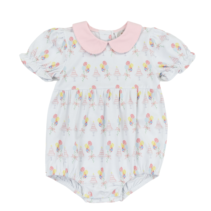 White Bubble romper with a pink collar that is printed with balloons and a birthday cake
