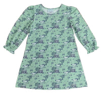 Green dress with a pattern on a wooden surface
