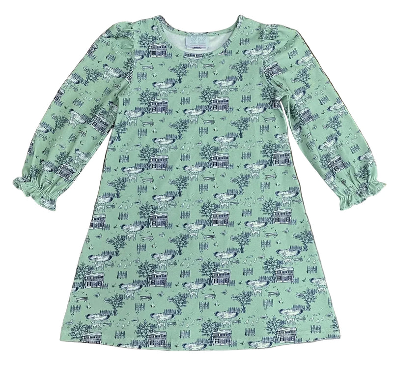 Green dress with a pattern on a wooden surface
